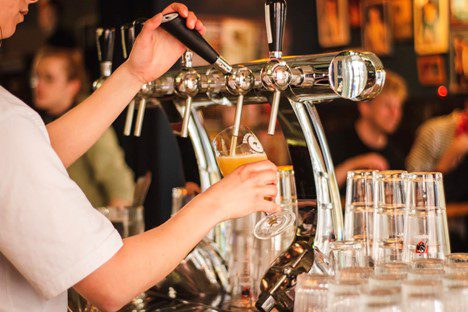 Bartender pouring beer from a tap