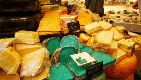 Different types of cheese stacked on a table