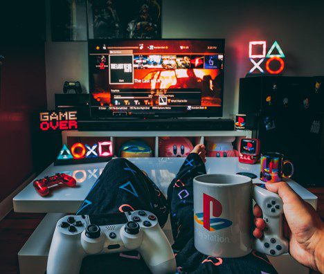 Mug and controller on lap in front of TV