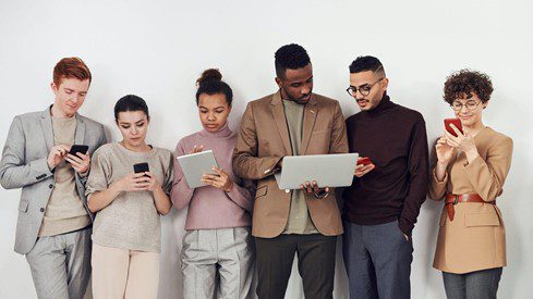 Group of people looking at handheld screens